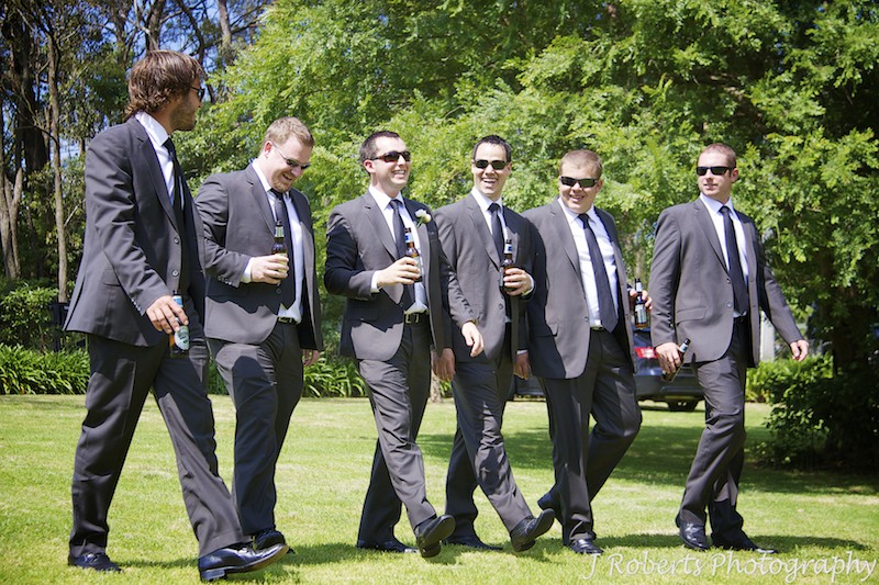 Groom walking with his groomsmen in gardens - wedding photography sydney